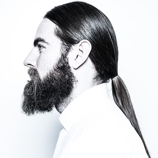 Sleek Low Ponytail + Full beard - men's haircuts