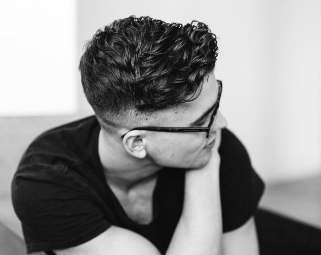 Curly hair styled on the side + Fade